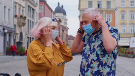 Senior-couple-tourists-grandmother-and-grandfather-wearing-medical-protective-coronavirus-mask