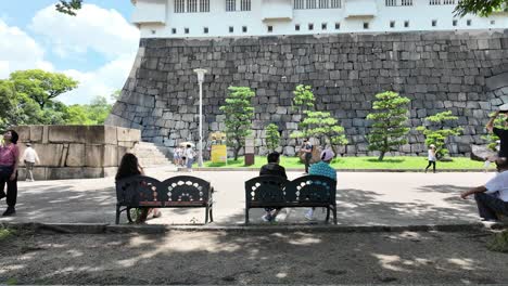 Street-scene-with-people-walking-and-a-cultural-building-in-the-background-in-Japan