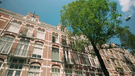 Low-angle-POV-footage-showcasing-Amsterdam-school-architecture-and-residential-houses-in-the-heart-of-the-city-center