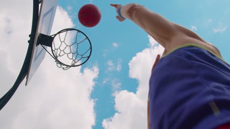 Upward-view-of-focused-senior-player-man-playing-basketball-game,-successfully-hits-into-basket-ring