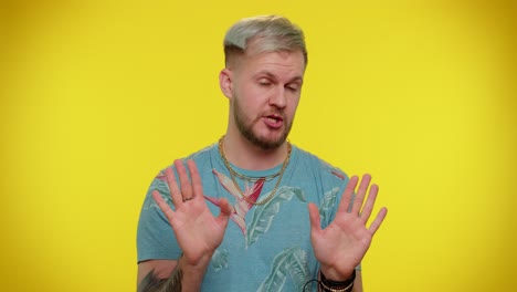 Man-on-yellow-studio-background-pointing-fingers-himself-ask-say-who-me-no-thanks-I-do-not-need-it