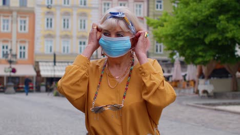 Coronavirus-pandemic,-portrait-of-senior-stylish-tourist-man-grandmother-wearing-protective-mask