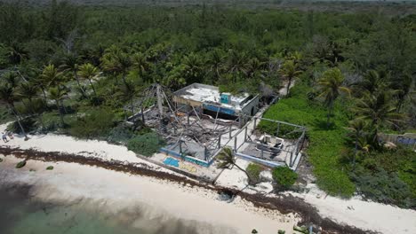 Tropical-beach-bar-ruins--damaged-by-hurricane,-aerial-view