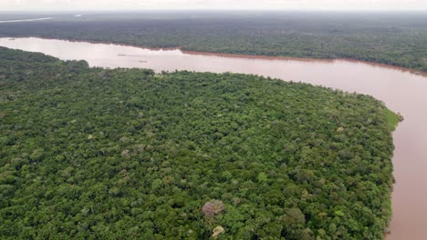 Aerial:-Large-fresh-water-river-going-through-thick-amazon-rain-forest,-Suriname