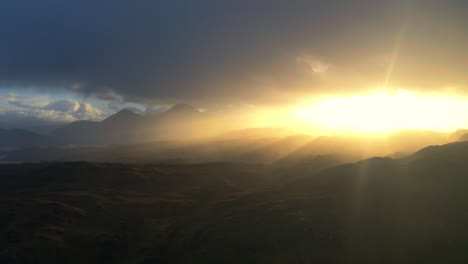 Sunrise-at-Scottish-West-highlands-with-magnificent-sun,-sea-and-landscape-at-rocky-shore,-drone-aerial