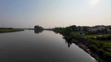 Aerial-view-along-the-Raritan-River-with-old-Power-Plant-in-Sayreville,-NJ