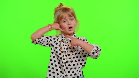 Funny-playful-child-girl-looking-at-camera-doing-phone-gesture-like-says-hey-you-call-me-back