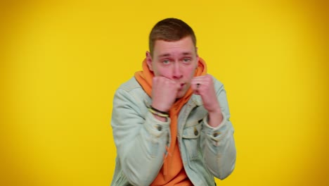 Aggressive-teen-man-trying-to-fight-at-camera,-shaking-fist,-boxing-with-expression,-punishment