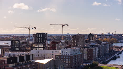 Time-lapse-of-cranes-constructing-apartment-buildings-in-Sompasaari,-Helsinki