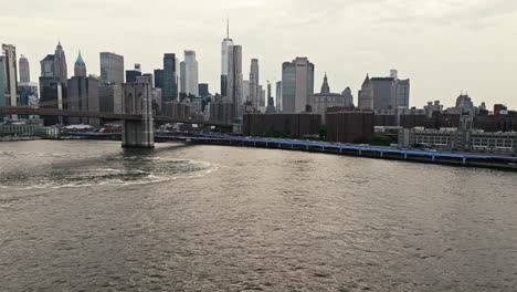 Medium-aerial-establishing-view-of-the-Brooklyn-bridge-and-tall-architectural-masterpieces-of-NYC