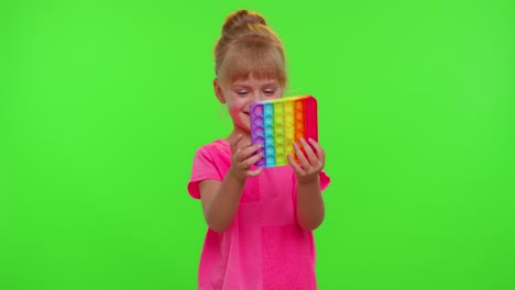 Child-girl-playing-squishy-silicone-bubbles-sensory-toy-simple-dimple-pop-it-game,-chroma-key