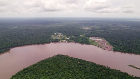 Aerial:-small-rural-village-in-the-amazon-jungle-by-the-Suriname-river,-with-dirt-roads