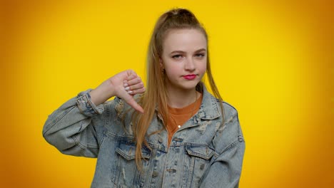 Upset-girl-in-denim-jacket-showing-thumbs-down-sign-gesture,-disapproval,-dissatisfied,-dislike