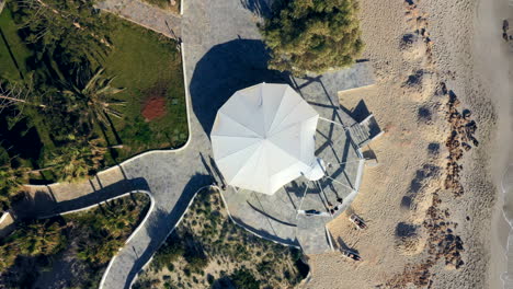 Aerial-ascending-shot-of-a-gazebo-by-the-beach