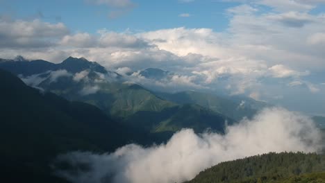 Aerial-drone-footage-of-the-Italian-Alps,-blue-skies-and-fluffy-clouds-just-after-rain