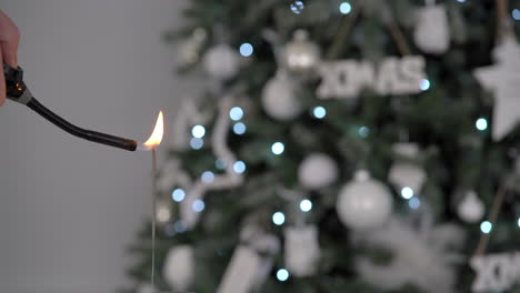 Newyear-party-firework-sparkler-with-blurry-Christmas-tree-in-the-background