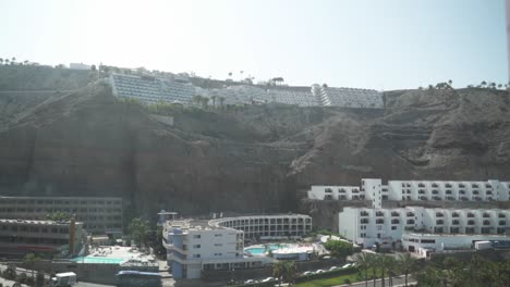 An-aerial-shot-of-a-hotel-complex-built-on-a-coastline-cliff