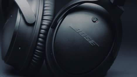 Detail-of-black-headphones-BOSE-on-a-pure-gray-background