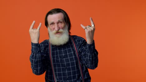 Overjoyed-delighted-crazy-elderly-man-showing-rock-n-roll-gesture-by-hands,-cool-sign,-dancing