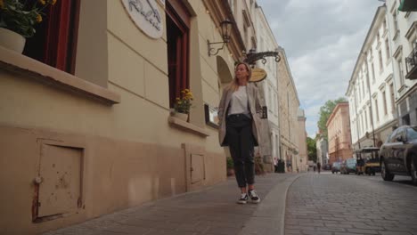 A-woman-strolls-past-the-eatery-on-the-Polish-city-of-Krakow's-street-on-a-sunny-day