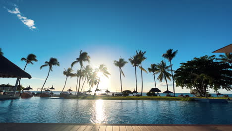 Beautiful-pool,-by-the-beach-and-the-palm-trees-at-luxury-tropical-resort