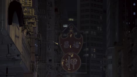 Night-view-of-a-street-in-Kowloon-district-of-a-pawn-shop-neon-sign-switching-off-in-Hong-Kong