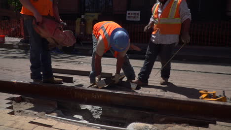 Workers-line-up-a-steel-beam-for-another-worker-to-cut-with-his-saw-in-Slow-motion