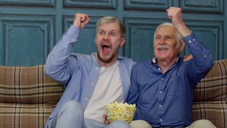 Abuelo-Mayor-Y-Hombres-Jóvenes-Viendo-Partidos-De-Fútbol-En-Televisión,-Familia-De-Generaciones-Masculinas