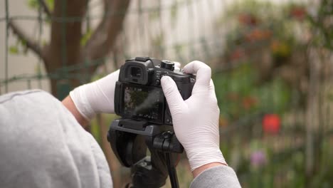 Man-wearing-mask-and-gloves-shoots-nature-stock-video-on-coronavirus-pandemic-crisis