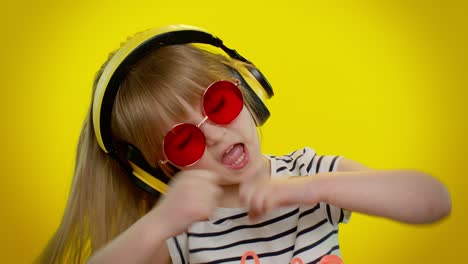 Young-blonde-teen-kid-child-girl-listening-music-via-headphones,-dancing-disco-fooling,-having-fun