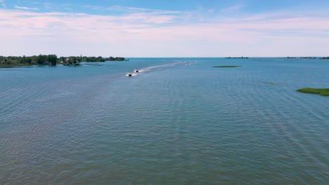 Boats-cruising-across-open-water-on-sunny-summer-day