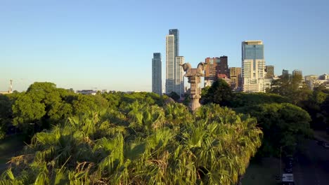 Aerial-rising-of-a-Persian-column-in-Bosques-de-Palermo-and-Buenos-Aires-buildings-in-background