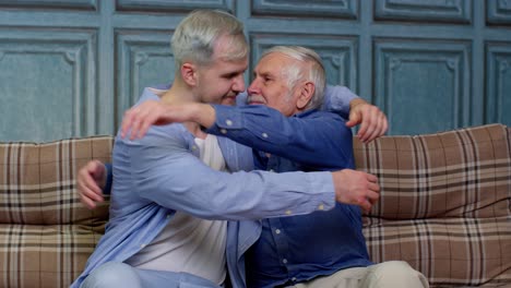 Joyful-excited-young-man-embracing-gray-haired-old-dad-or-grandfather,-male-generations-family