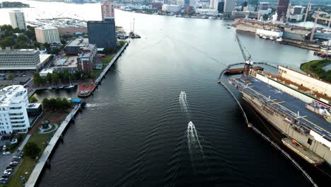 Aerial-Over-Elizabeth-River-With-Two-Boats-Navigating-Along-Past-General-Dynamics-Nassco-Shipyard