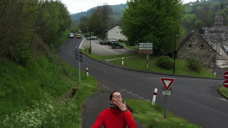 Woman-having-fun-blowing-kisses-at-the-camera-in-a-red-top-and-glasses