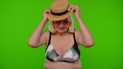 Senior-woman-tourist-in-swimsuit-wearing-hat,-waving-hands-hi-hello-welcome-greetings-on-chroma-key