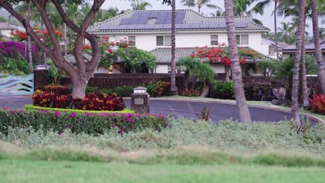 Beautiful-luxurious-villas-of-touristic-complex-surrounded-by-beautiful-gardens,-tropical-flowers-and-palm-trees-in-Hawaii