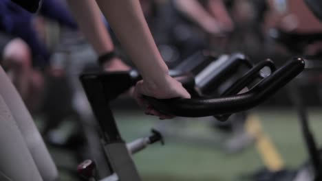 Girl-in-spin-class-holds-onto-the-bike