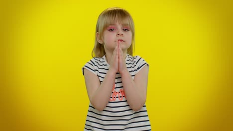 Kid-child-girl-praying,-making-wish,-asking-with-hopeful-imploring-expression,-begging-apology