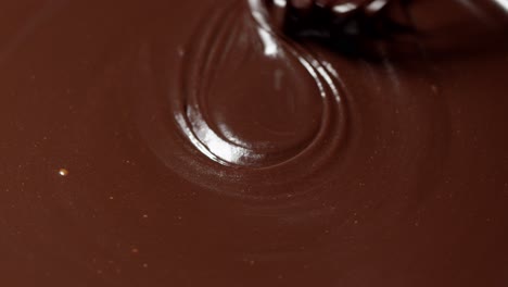 Mixing,-stirring-melted-liquid-dark-chocolate-with-whisk,-confectioner-prepares-dessert,-topping