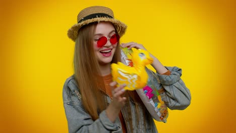 Traveler-tourist-student-girl-dancing-fooling-with-swimming-ring-and-duck-toy-travel-on-weekends