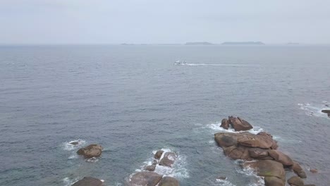 Aerial-Drone-view-above-French-Bretagne-granite-coast-on-cloudy-time-and-fog