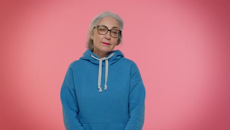 Playful-happy-elderly-granny-woman-blinking-eye,-looking-at-camera-with-smile,-expressing-optimism