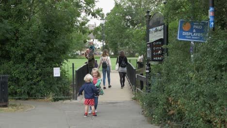 Women-and-two-kids-walking-over-bridge-to-park-as-coronavirus-rules-relax