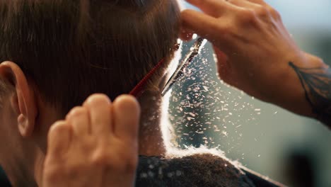 Man-getting-hair-cut-with-scissors