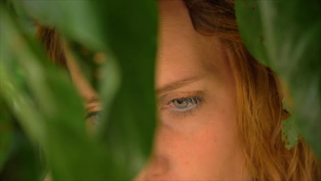 Beautiful-girl-with-blue-eyes-looking-into-the-camera-in-tropical-scenery