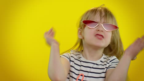 Stylish-happy-kid-child-girl-in-sunglasses-listening-music-dancing-disco,-fooling-around,-having-fun