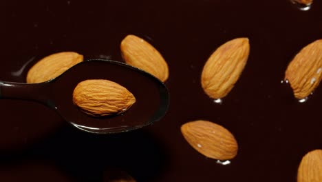 Melted-liquid-dark-chocolate-and-almond-rotating,-close-up-top-view-of-molten-liquid-hot-chocolate