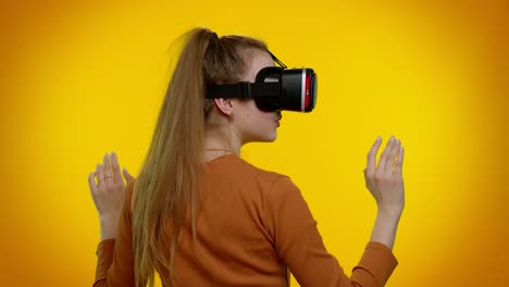 Girl-using-virtual-reality-futuristic-technology-VR-headset-helmet-to-play-simulation-3D-video-game