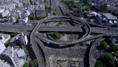 Aerial-shot-of-Argentinian-football-soccer-fans-take-over-intersection-of-Arturo-Frondizi's-Highway-in-Buenos-Aires